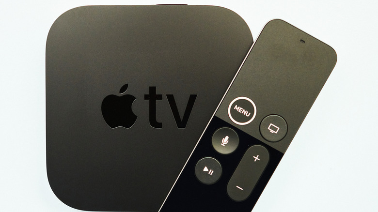 An Apple TV 4K HD box and remote control.