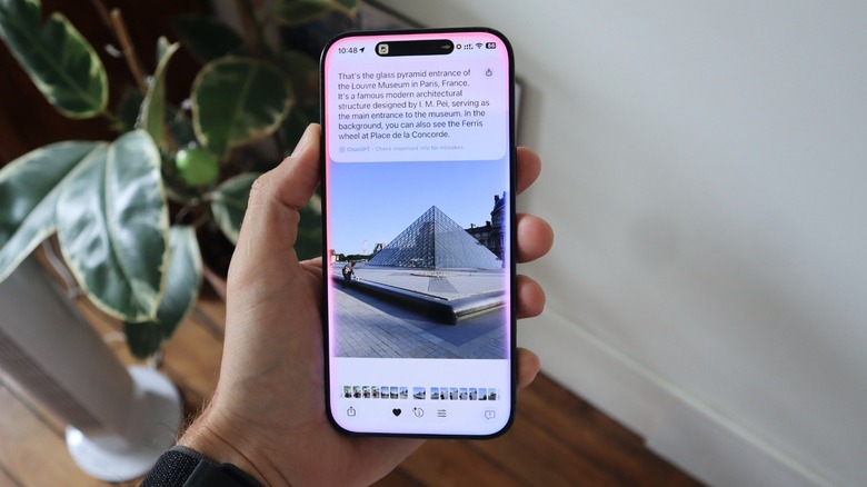 ChatGPT prompt overlayed over a picture of the Louvre in France on iPhone