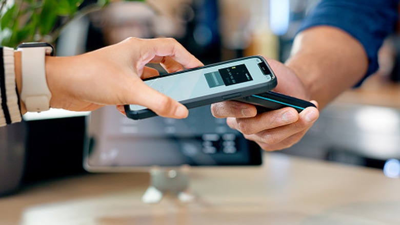 Cashier, customer and phone for POS machine for restaurant fintech, digital payment and easy checkout services.