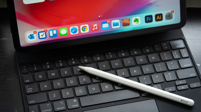 Apple Pencil resting on a magic keyboard attached to an iPad