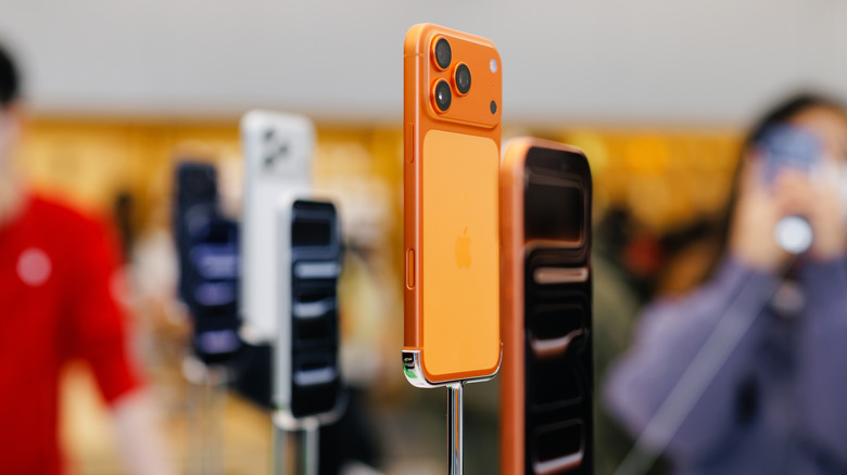 Cosmic Orange Apple iPhone 17 Pro Max smartphones displayed on stands