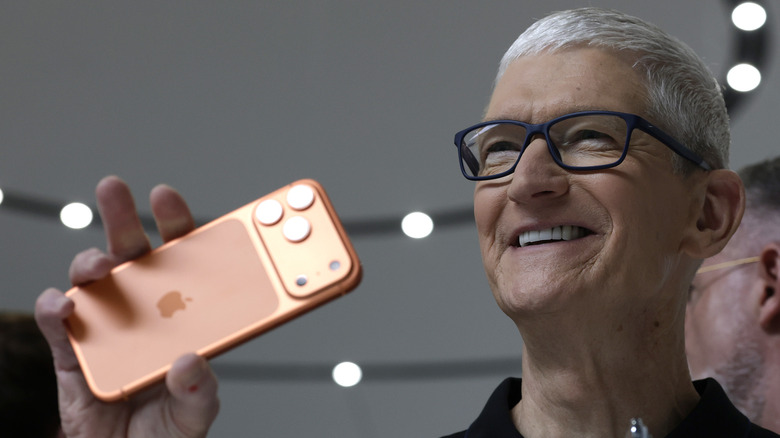 Apple's CEO Tim Cook holding an iPhone 17 Pro Max at the Apple Park