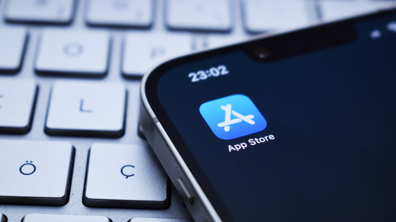 iPhone's App Store with a keyboard in the background