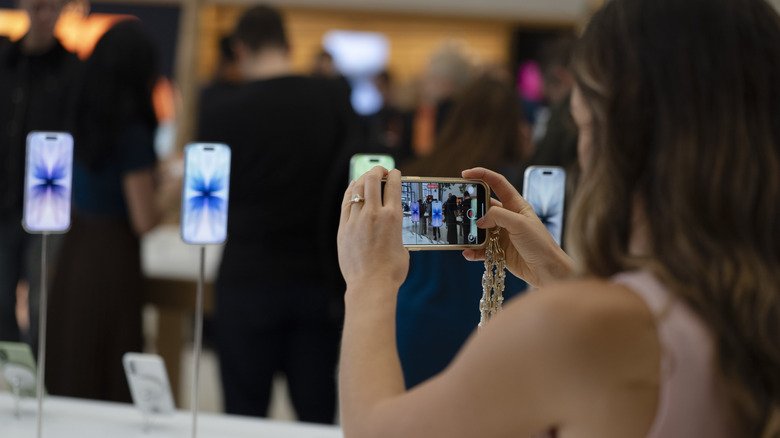 iPhone 17 in hand at Apple retail store