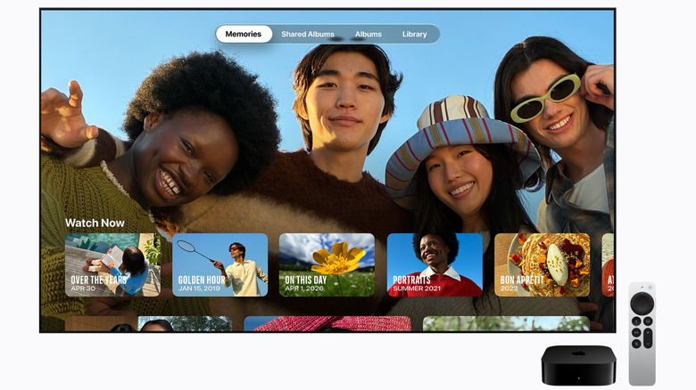 Apple TV 4K box and remote in front of a TV screen