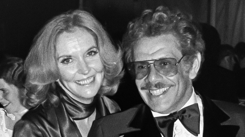 A black and white photo of an older man and woman dressed in formal wear