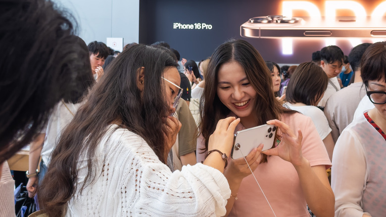 People experiencing the iPhone 16 launch in an Apple store.