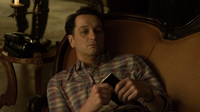 Tom laying on an ornate couch.
