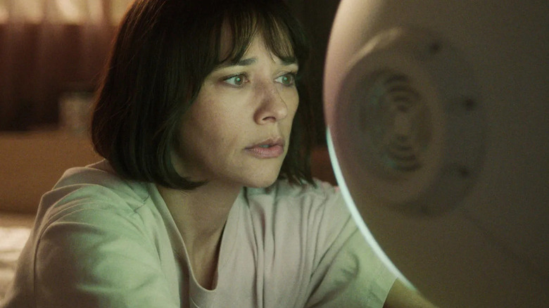 Rashida Jones looking at her robot in 