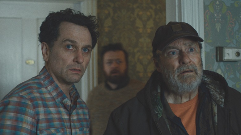 Matthew Rhys and Stephen Root both looking perplexed and horrified in a scene from the Apple TV series 