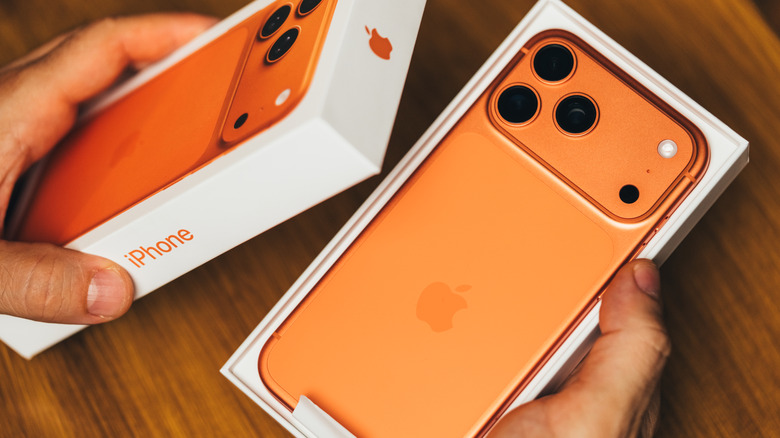 A person unboxing an iPhone 17 Pro Max.