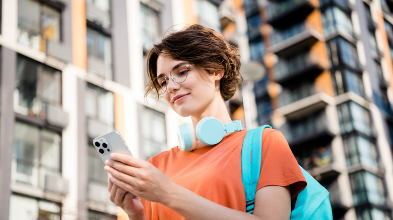 A woman looking at her iPhone screen