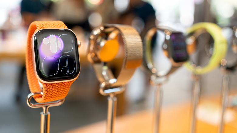 Several Apple Watch Series 11 smartwatches on display in a store.