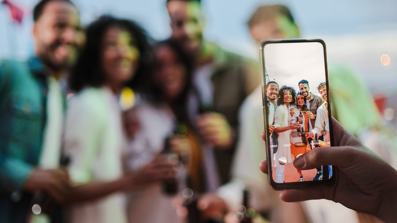 A person taking a picture of a group of people