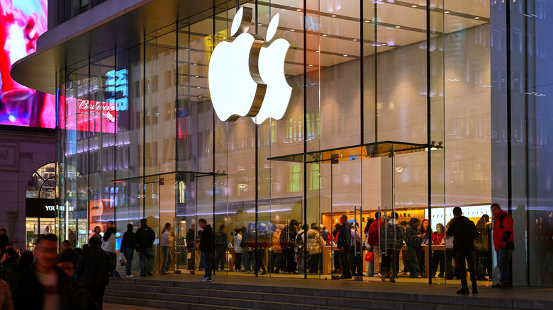 apple store with a glass facade with people inside and outside