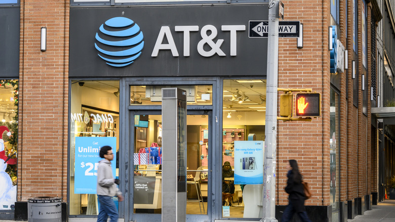 People walk outside of an AT&T store