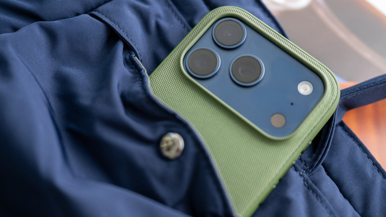 Close up of iPhone 17 Pro in Deep Blue color in a green TechWoven case
