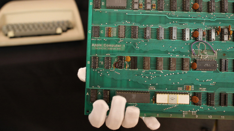 Apple I board being held with gloves