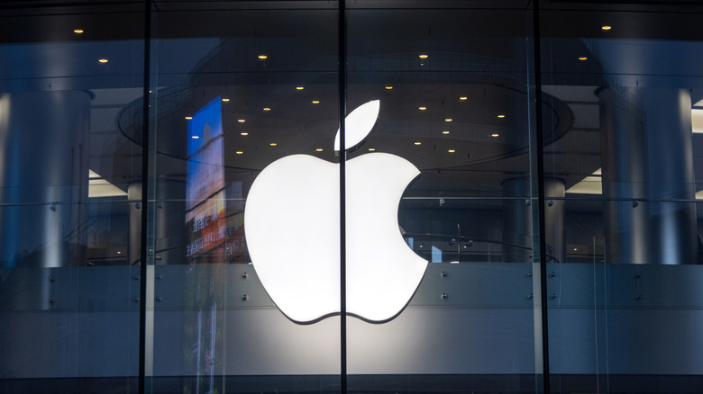 Apple logo shining outside an Apple retail store