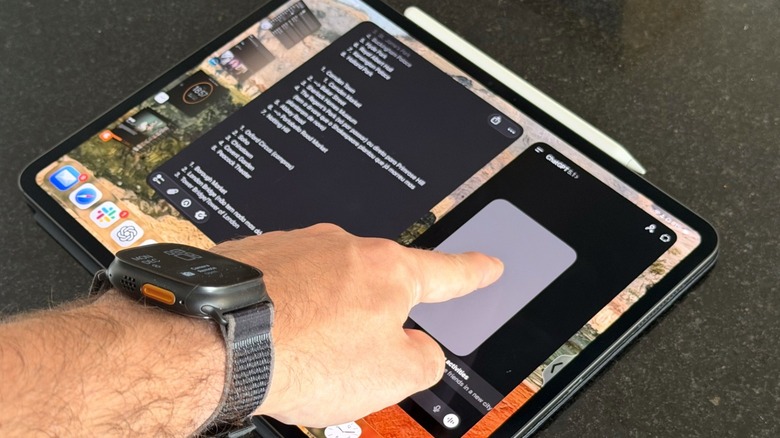 A hand touching the iPad Pro M4 with an Apple Pencil Pro attached to it