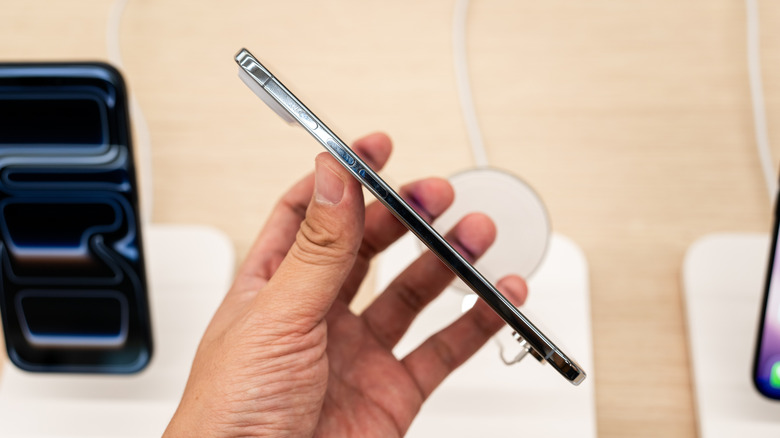 A person holding an iPhone Air at a store