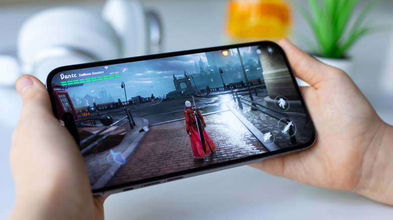 Child playing an iOS game on an iPhone