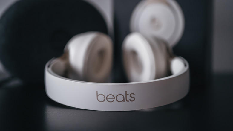 A pair of Beats Solo headphones sitting on a table with the logo headband in closeup