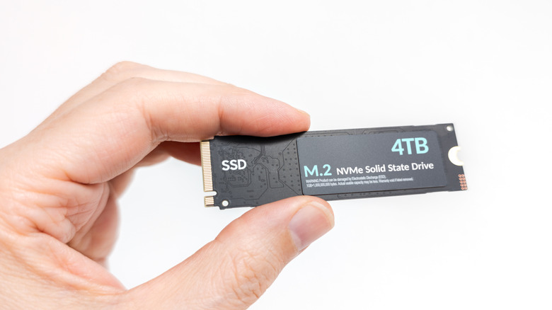Hand holding an NVMe SSD