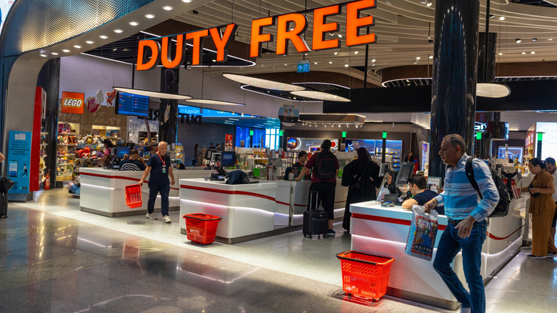 The entrance to a duty-free shop in an airport with customers out front.