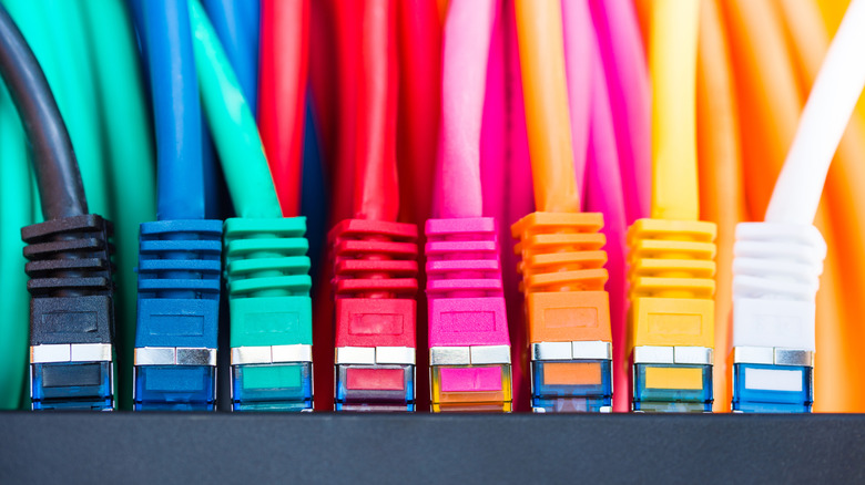 A series of colorful Ethernet cables plugged into a device