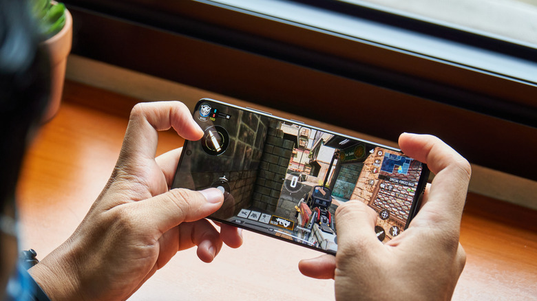 a person playing a video game on a Samsung Galaxy phone