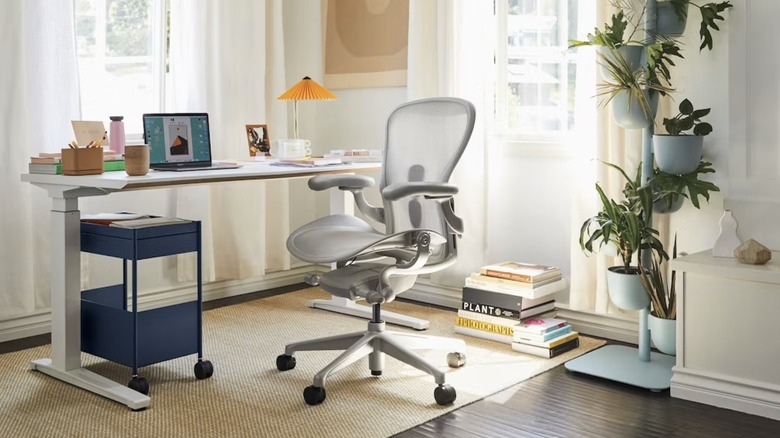 Herman Miller's Aeron chair at a desk in a home office.