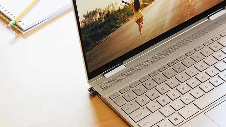 SanDisk Ultra Fit mini drive plugged into USB port on side of laptop