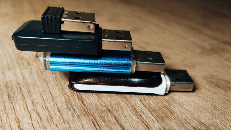 Multiple thumb drives and USB drives stacked on top of one another