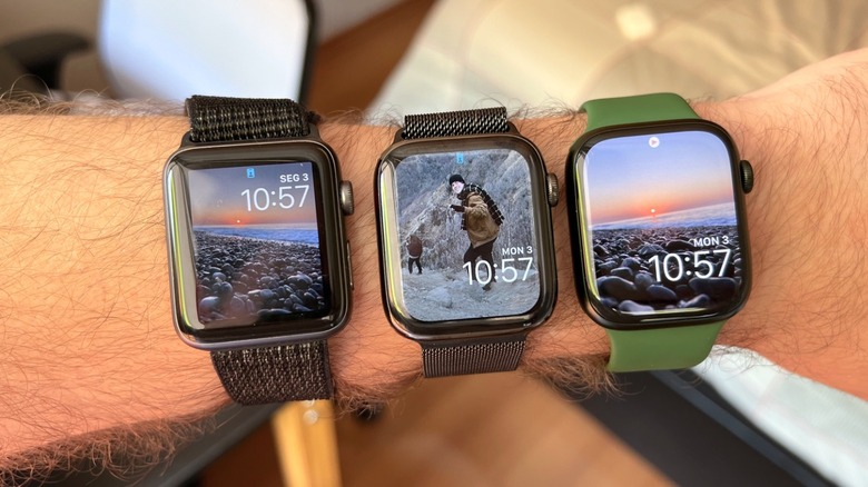 A man's arm with several Apple Watches on