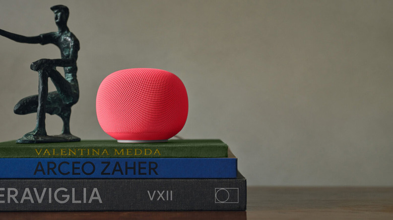 A Google smart speaker atop a stack of books.