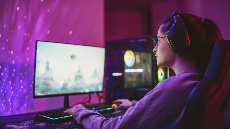A person sitting and gaming on a computer