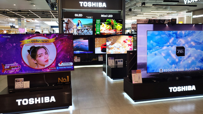 A Toshiba display showing various OLED and Mini LED TVs