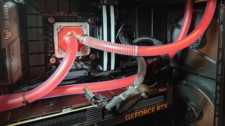 An Nvidia RTX graphics card inside a high-performance gaming PC with water cooling.