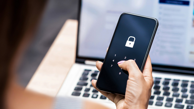 A woman entering a PIN code on her phone