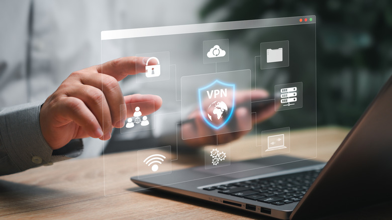 VPN displaying options over a laptop with a finger touching the lock symbol