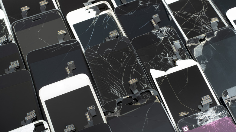 Broken smartphones lined up and organized in rows.