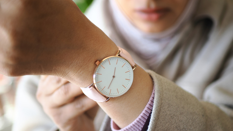 a person wearing a traditional wrist watch