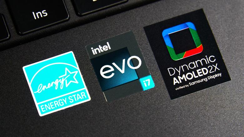 Stickers advertising Energy Star, Intel evo i7, and a Samsung Dynamic AMOLED 2X display are stuck to the bottom of a black laptop