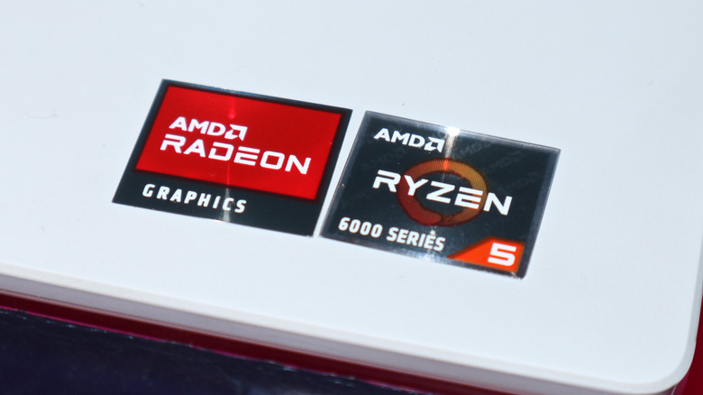 Two stickers -- one for AMD Radeon graphics and another for AMD Ryzen 6000 Series 5 -- are attached at the corner of a white laptop