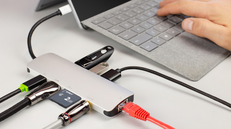 A USB hub on a desk with every port being used.