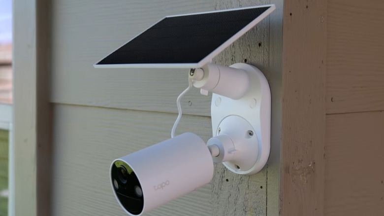 a TP Link solar powered security camera mounted to an outdoor wall