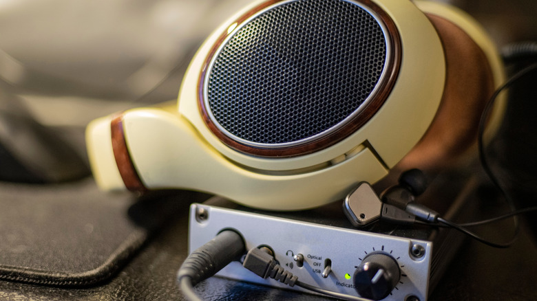 A pair of high-end headphones sitting on top of a high-quality DAC and headphone amp