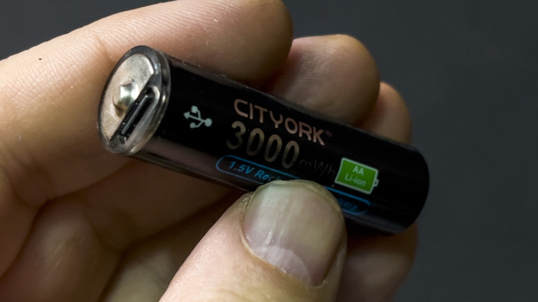 A hand holding a USB rechargeable battery