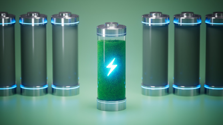 A line of batteries, one filled with green matter with a lightning bolt symbol on the front